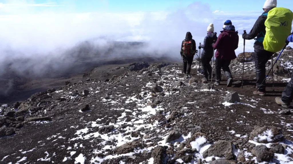 Climber wearing proper layered clothing on Mount Kilimanjaro What to wear on Kilimanjaro | KILIMINJARO CLIMBING CLUB